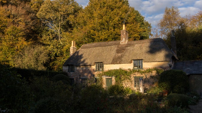 Hardy's Cottage in autumn in late afternoon sunshine in Dorset.
